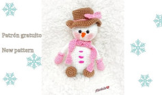 Snowman crochet pattern with brown hat and pink scarf.