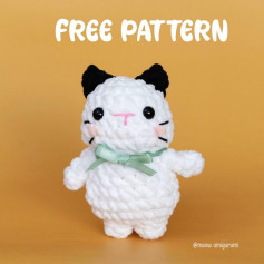 white cat crochet pattern with black ears.