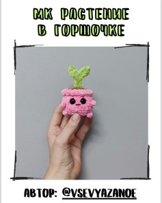 Смешное вязаное растение в горшке с лицом и лапками.
