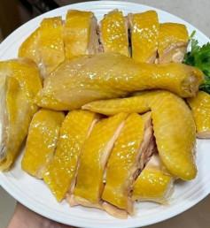 Gà luộc vàng với thảo mộc thơm và gừng