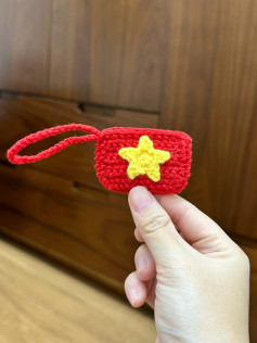 Crochet Keychain with Yellow Star Pattern on Red Background