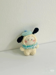 Cute crochet plushie with blue hat and scarf.