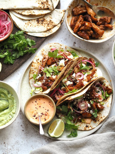 Spicy Sriracha Chicken Tacos with Lime Guacamole and Pickled Onion