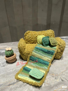 Cozy Crochet Sofa with Colorful Blanket and Miniature Cactus
