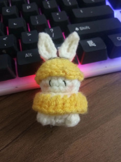 Cute Crochet Bunny in Yellow Outfit on Keyboard