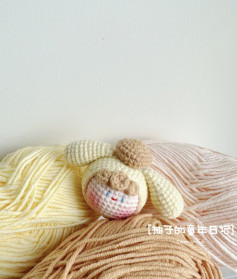Cute Crochet Bunny Toy Surrounded by Colorful Yarn Balls