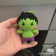 Cute Crochet Green Character with Black Hair and Purple Shorts