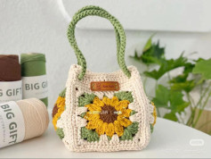 Sunflower Crochet Bag Pattern with Green Handle and Yarn Background