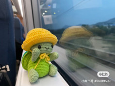 Crochet Turtle Enjoying a Scenic Train Ride with Yellow Hat