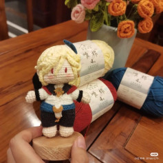 Handmade Crochet Doll with Colorful Yarn Background