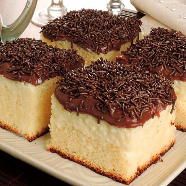 Bolo de leite condensado molhadinho com cobertura chocolate e granulado