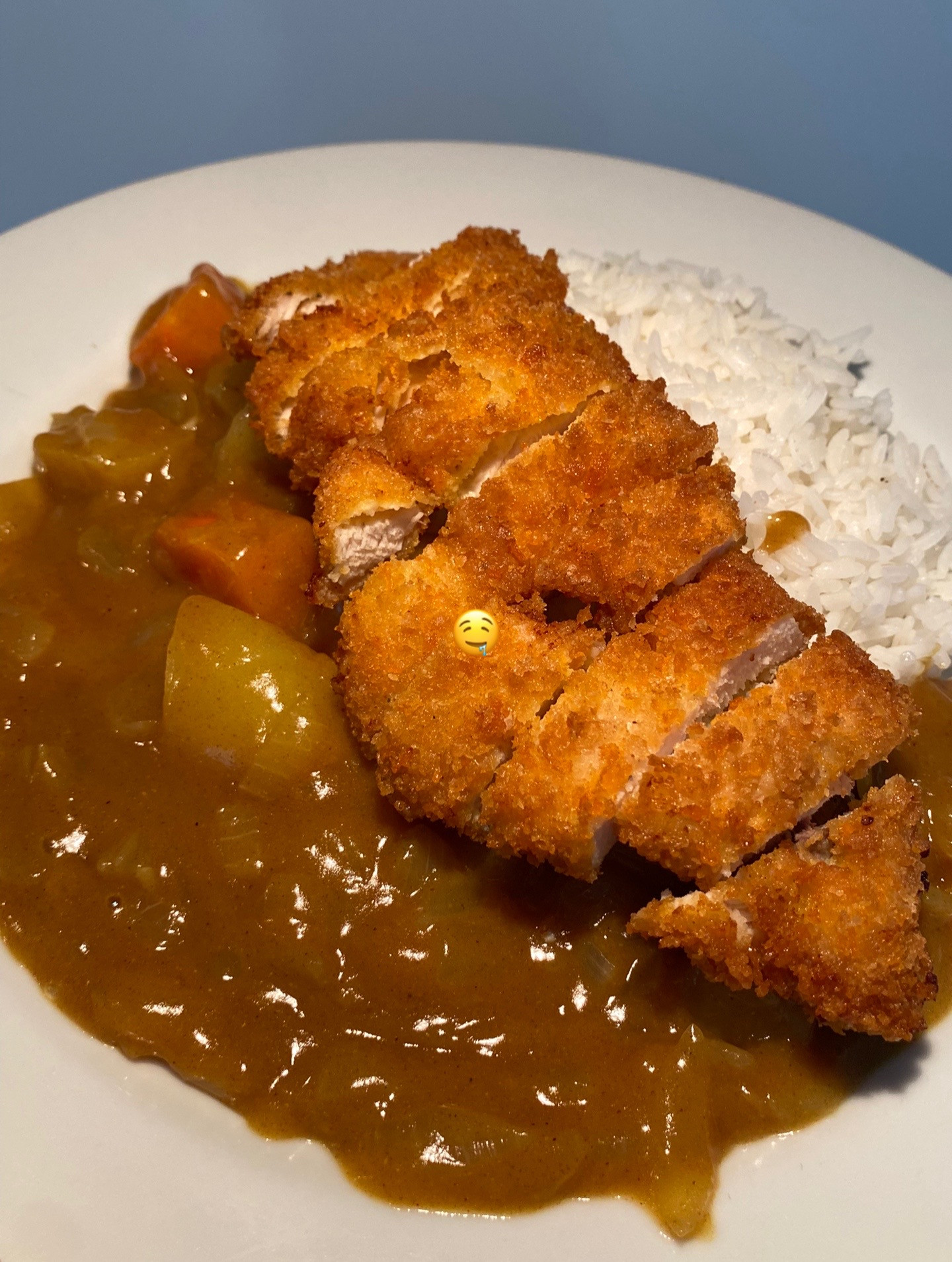 Chicken Katsu Curry with rice, crispy fried chicken breast served in savory curry sauce