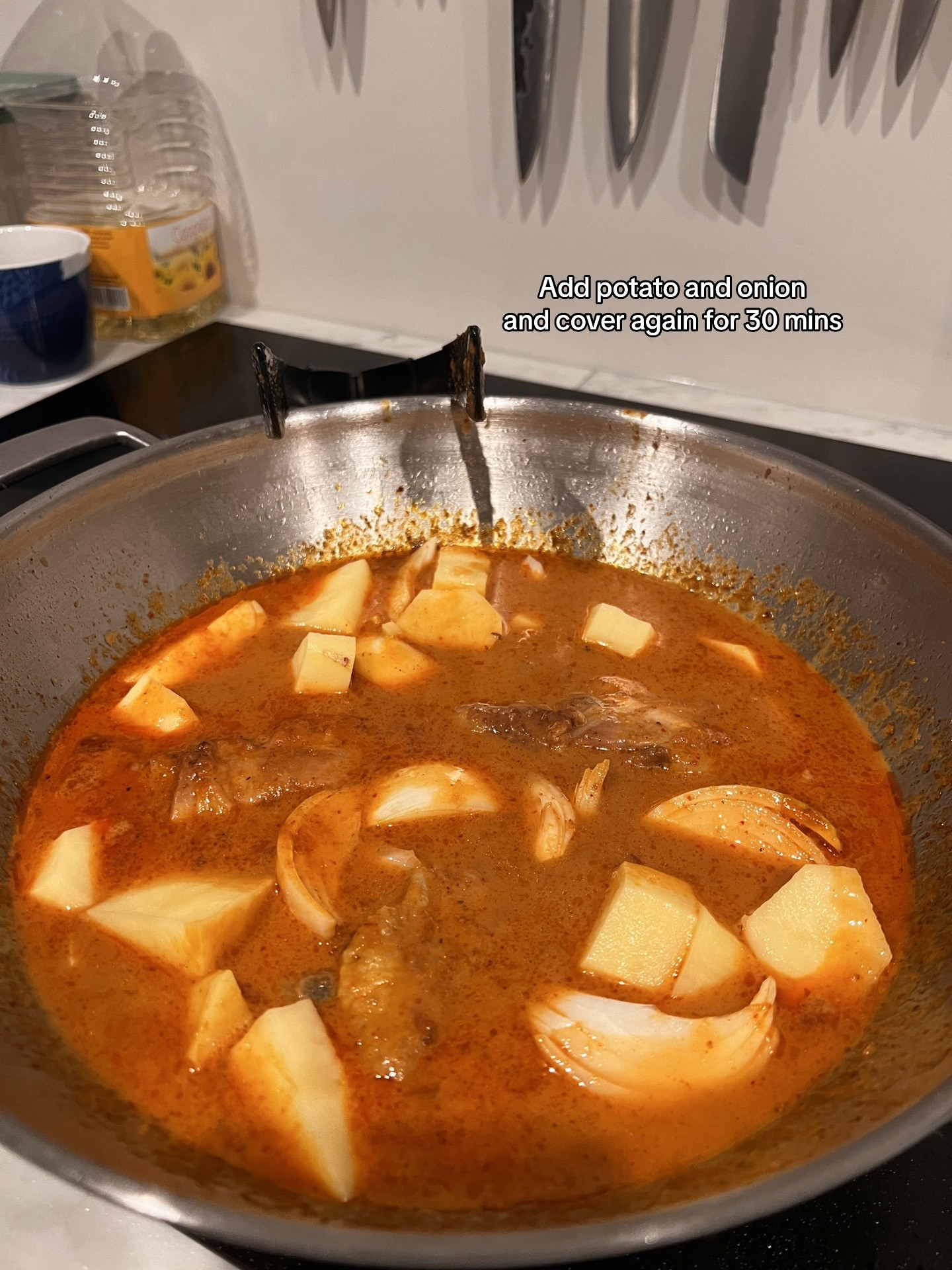 Chicken Massaman Curry with rice, topped with cashew & coriander