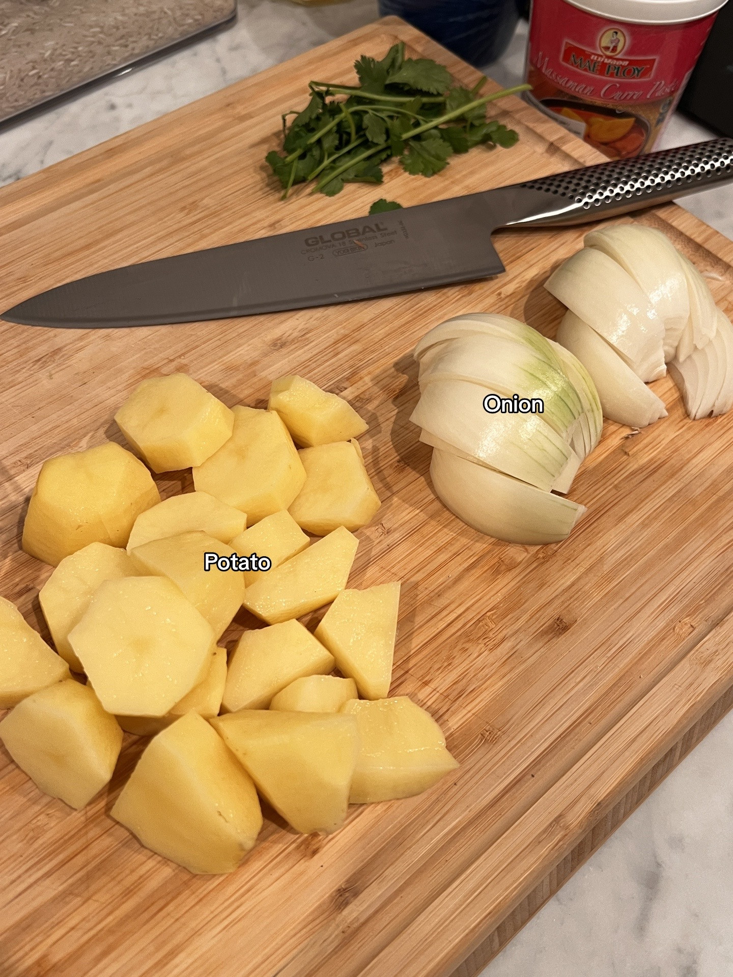 Chicken Massaman Curry with rice, topped with cashew & coriander