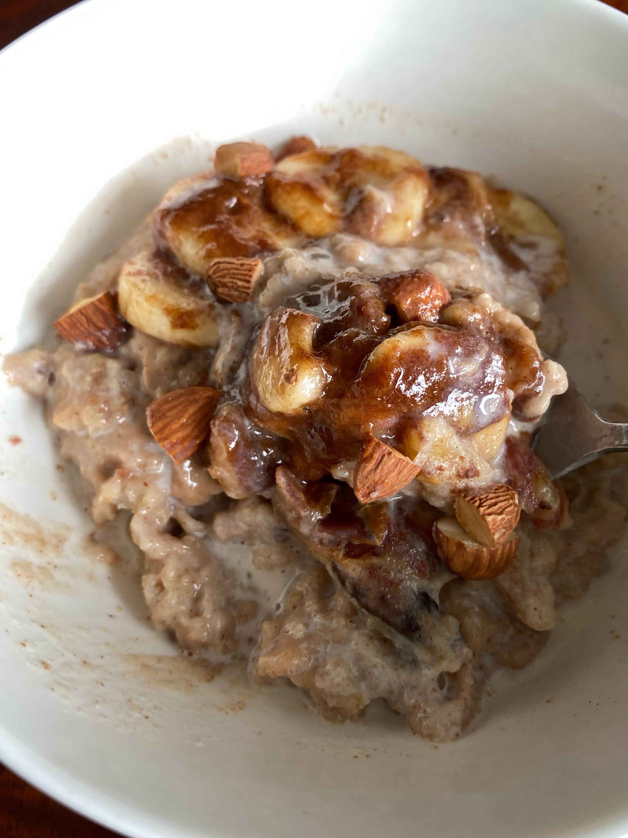 Creamy oatmeal with caramelized banana, cinnamon, and warm milk