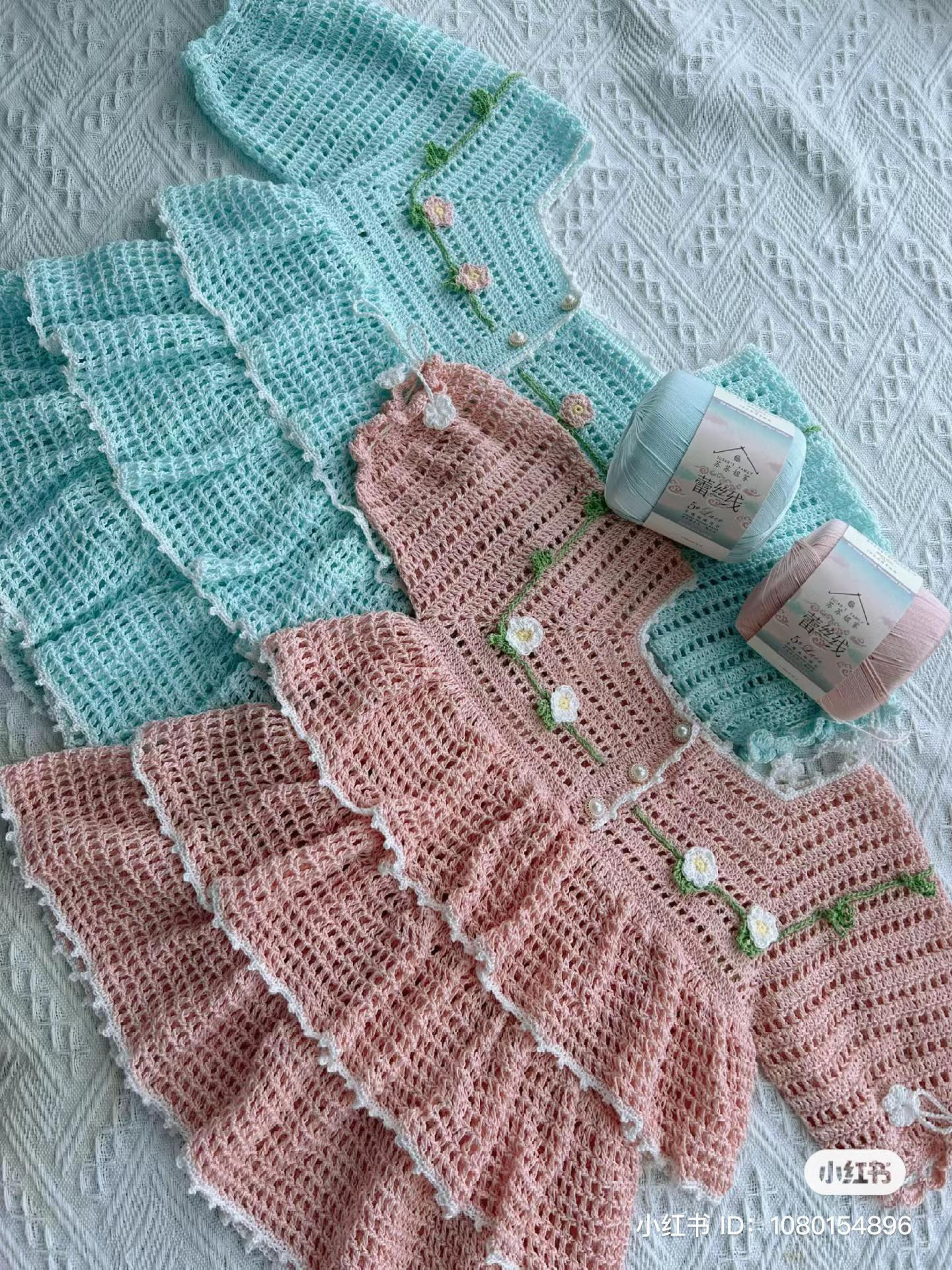 Hand-drawn crochet chart pattern for a baby dress with tiered ruffles and floral embroidery details