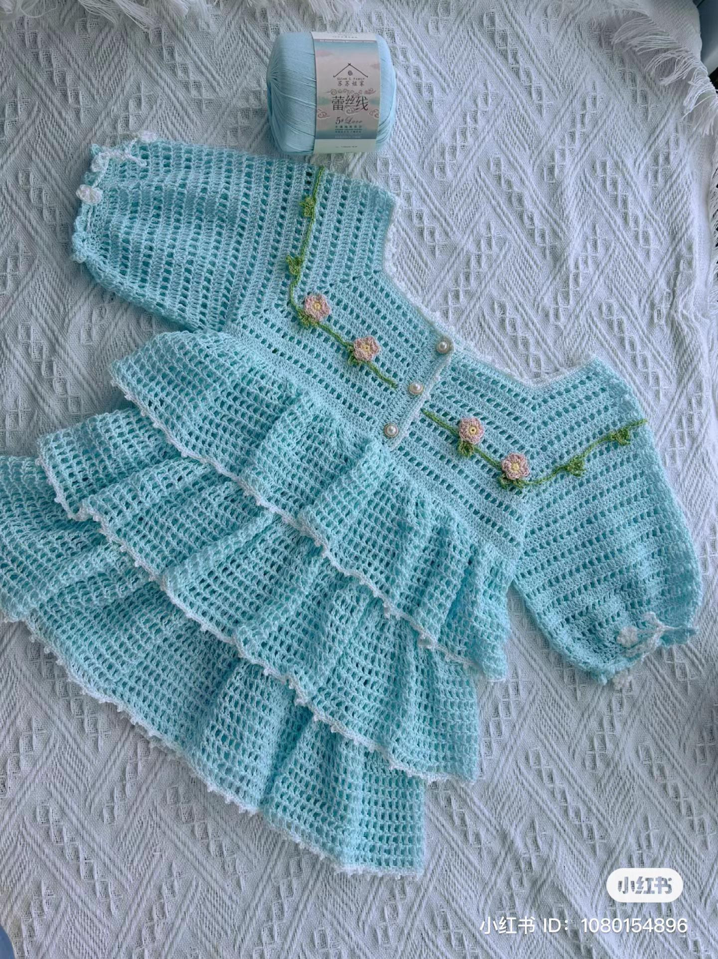 Hand-drawn crochet chart pattern for a baby dress with tiered ruffles and floral embroidery details