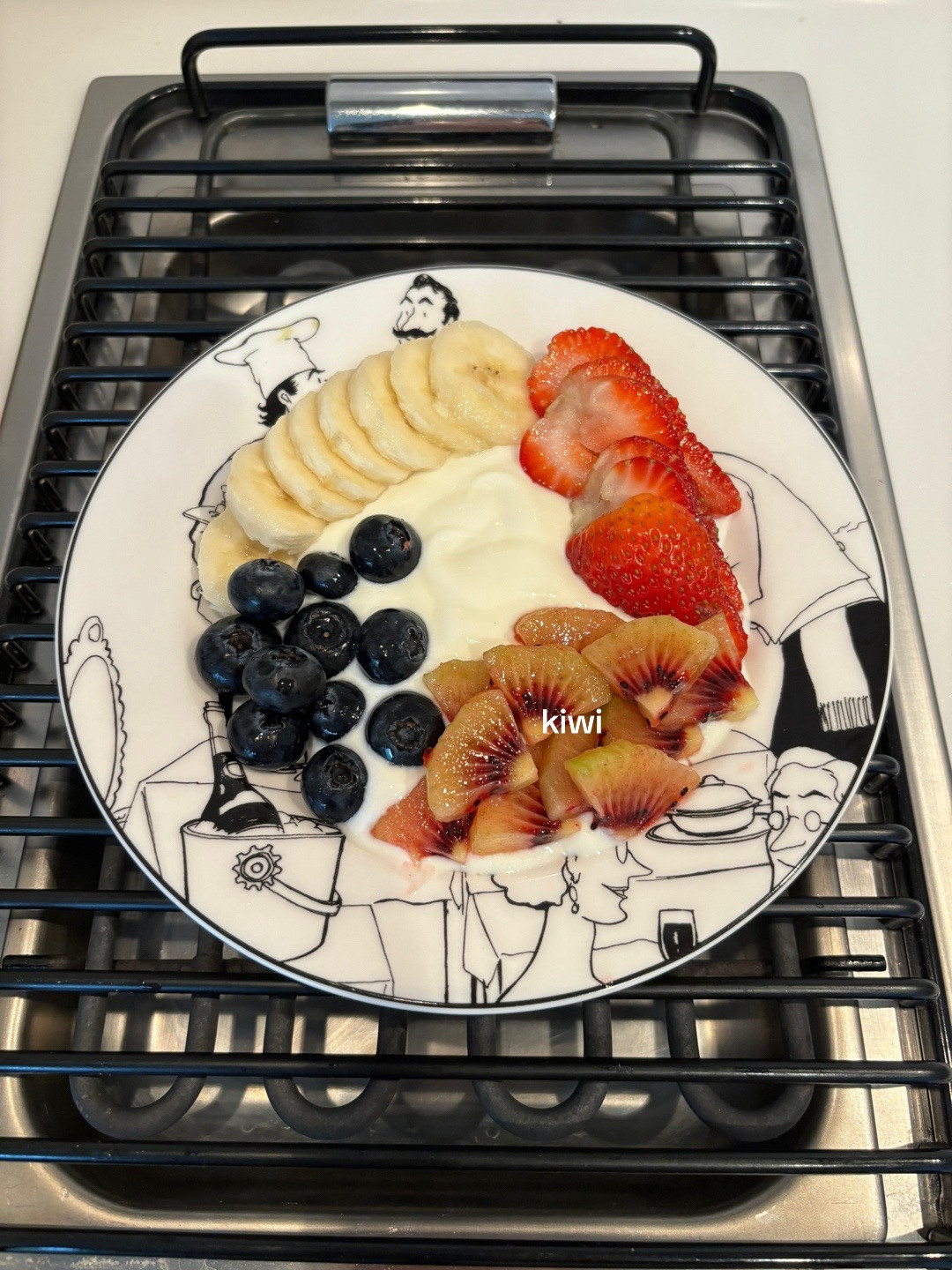 Healthy Yogurt Granola Bowl with Banana, Strawberries, Blueberries and Kiwi