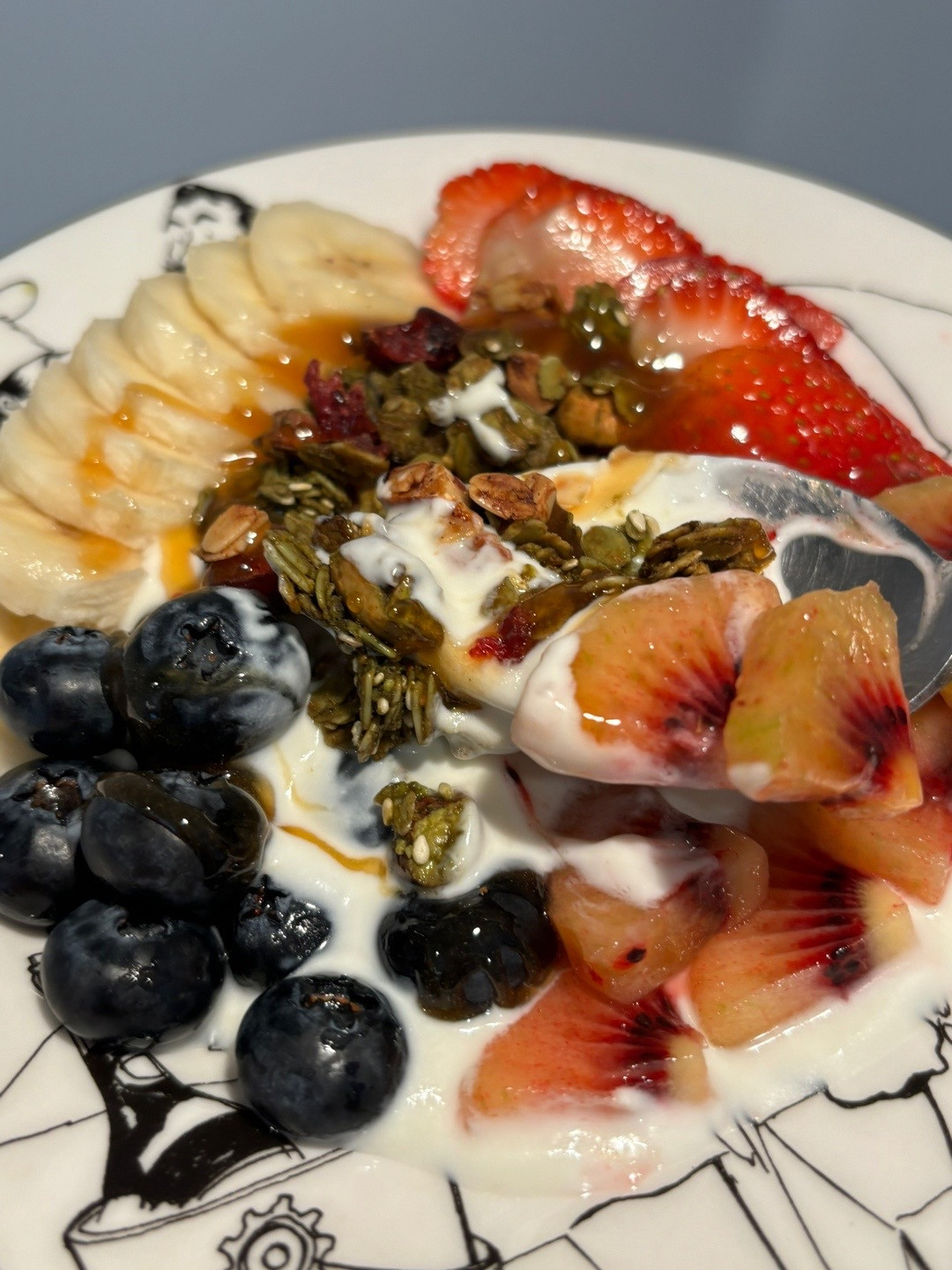 Healthy Yogurt Granola Bowl with Banana, Strawberries, Blueberries and Kiwi