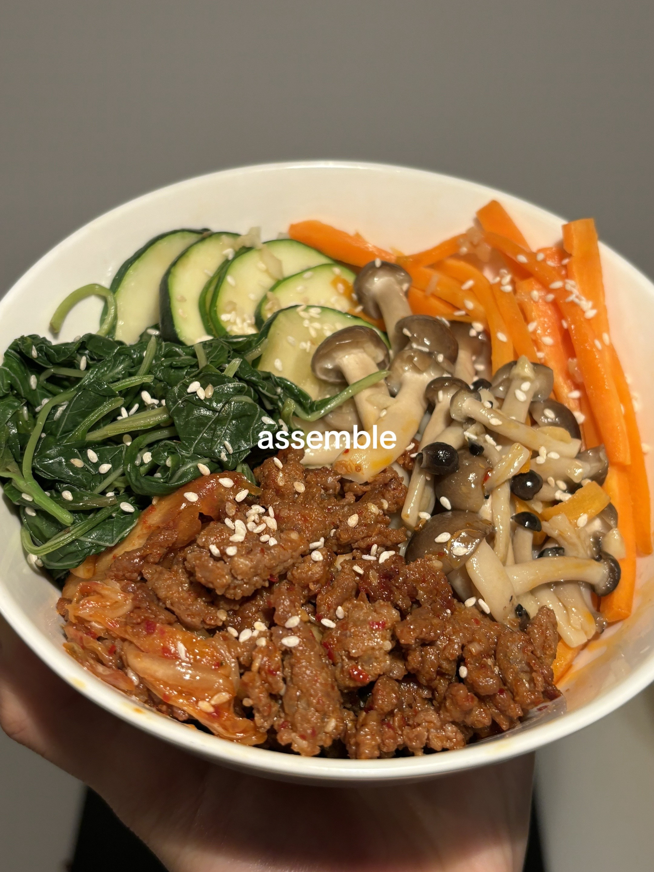 Homemade Beef Bibimbap with Gochujang Sauce, Kimchi, Spinach, Mushrooms and Fried Egg