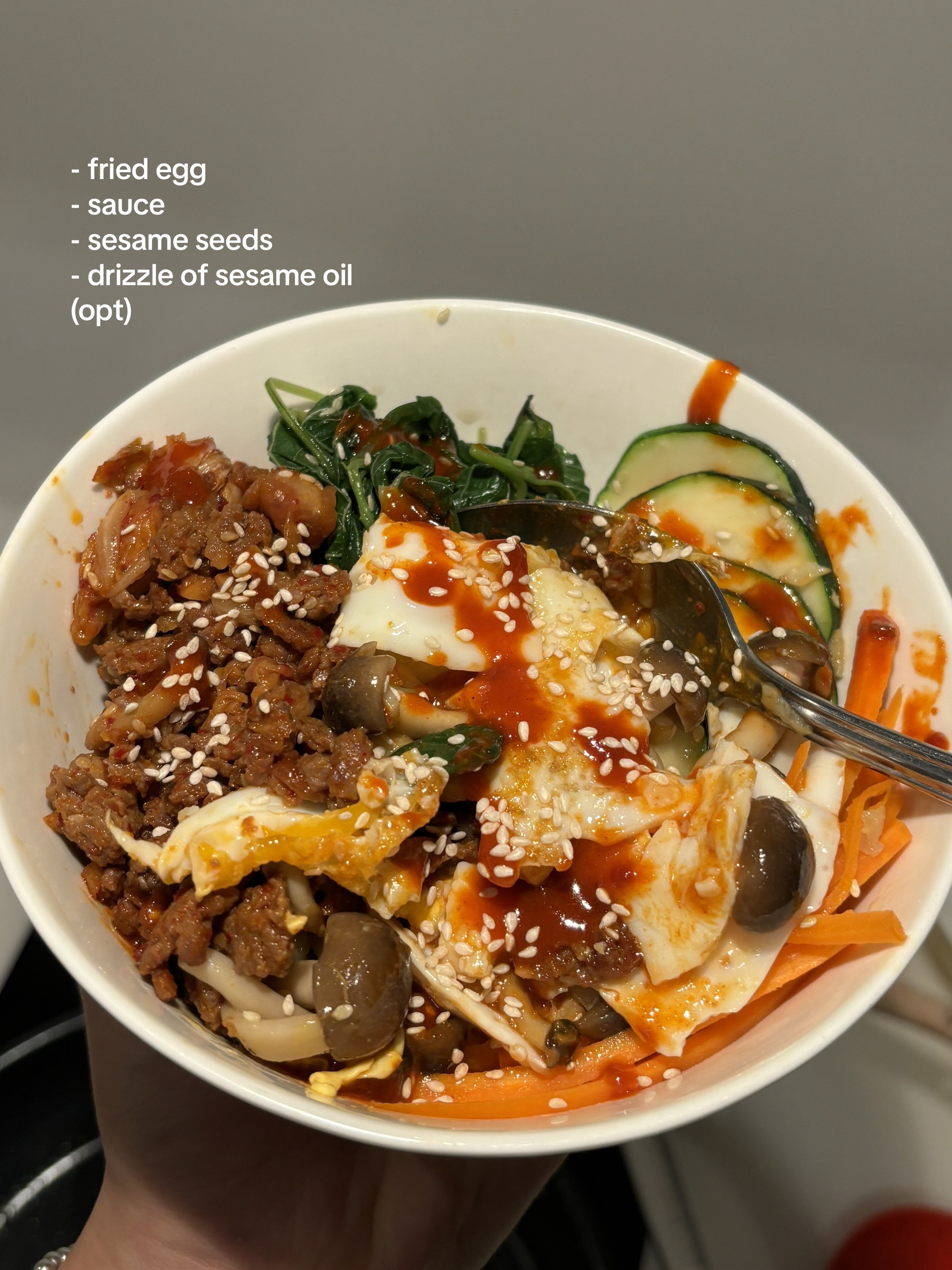 Homemade Beef Bibimbap with Gochujang Sauce, Kimchi, Spinach, Mushrooms and Fried Egg