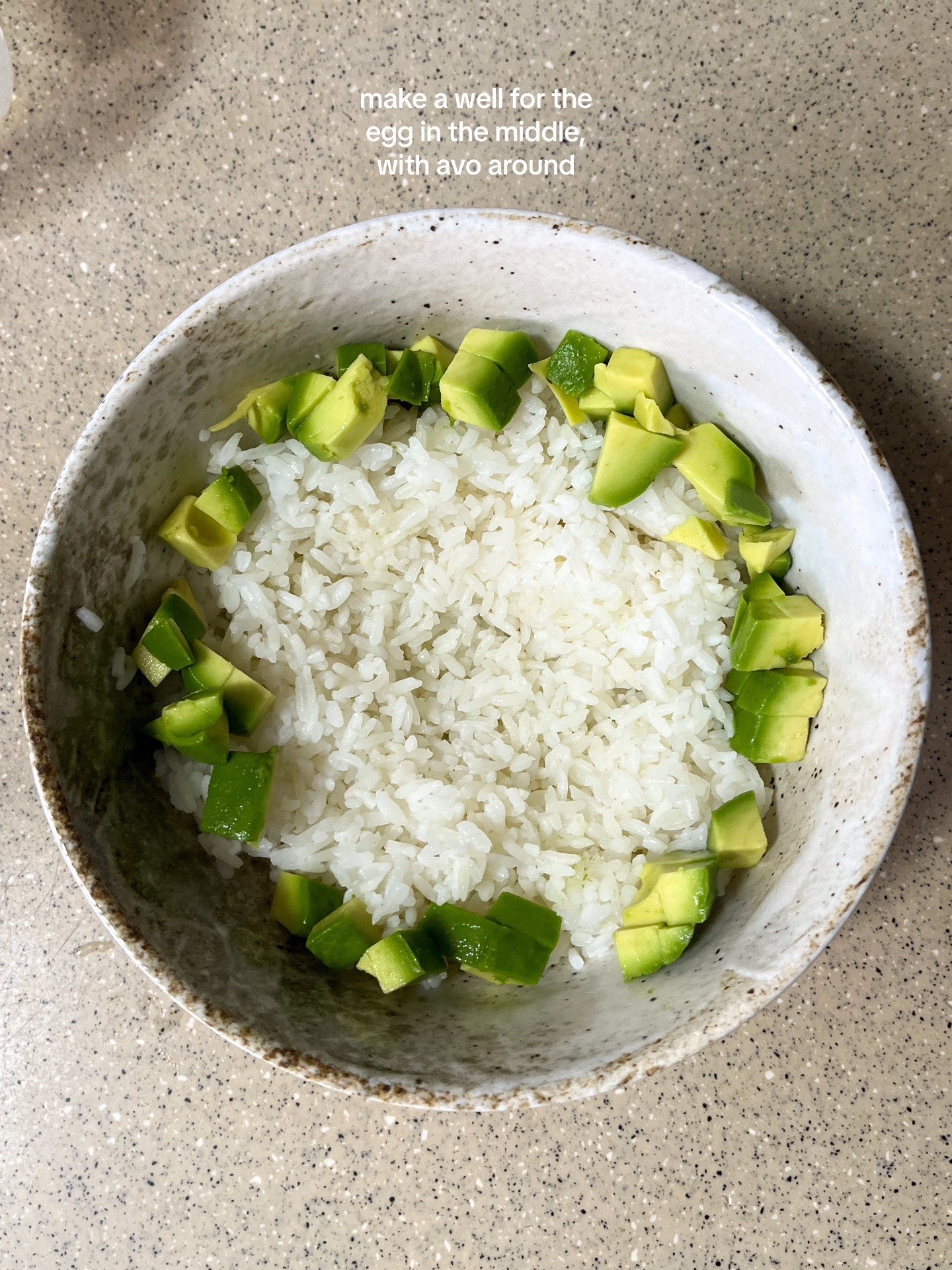 How to make a simple and nourishing onsen egg bowl with rice, avocado, furikake, garlic chips, and sesame