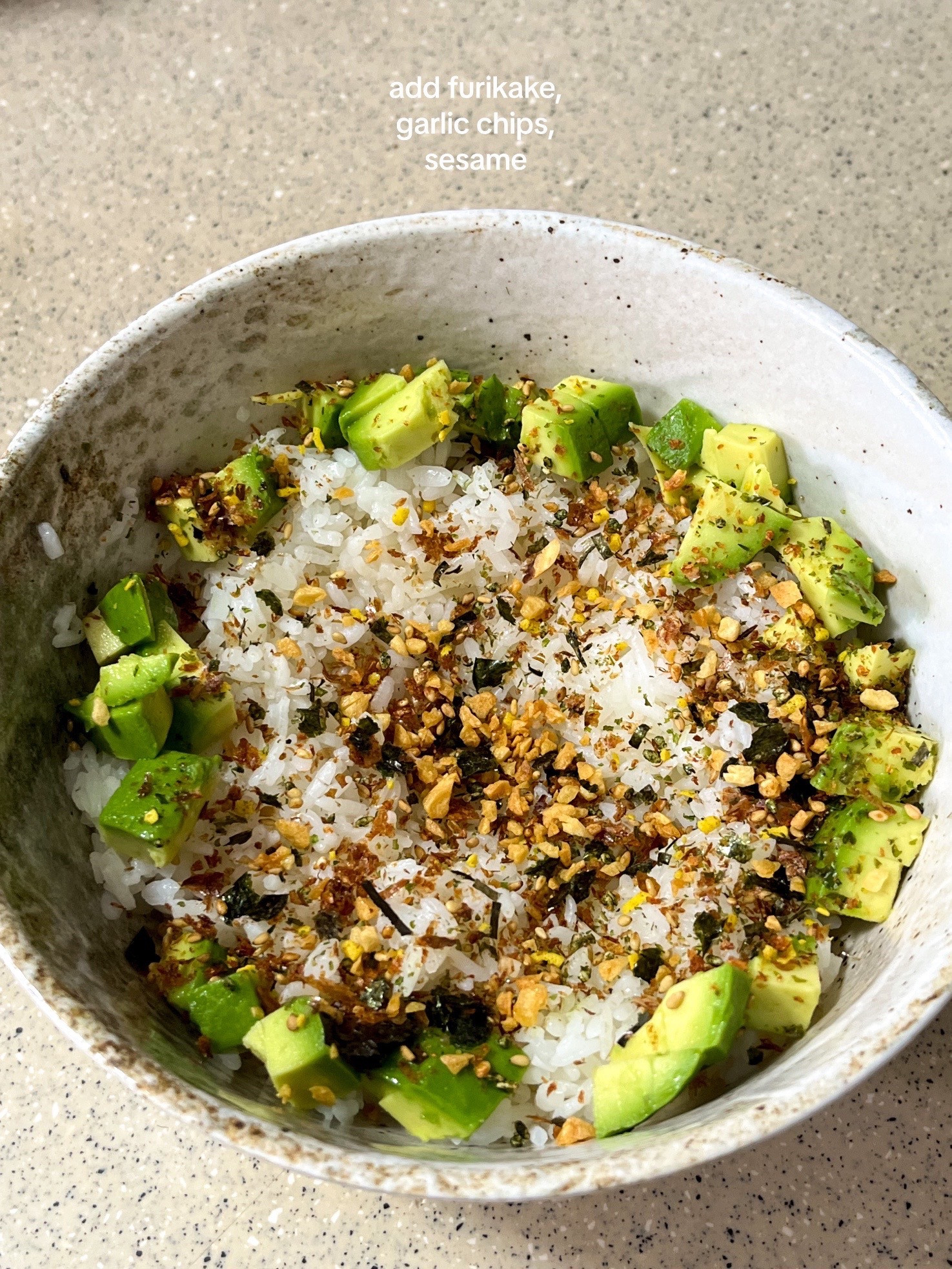 How to make a simple and nourishing onsen egg bowl with rice, avocado, furikake, garlic chips, and sesame