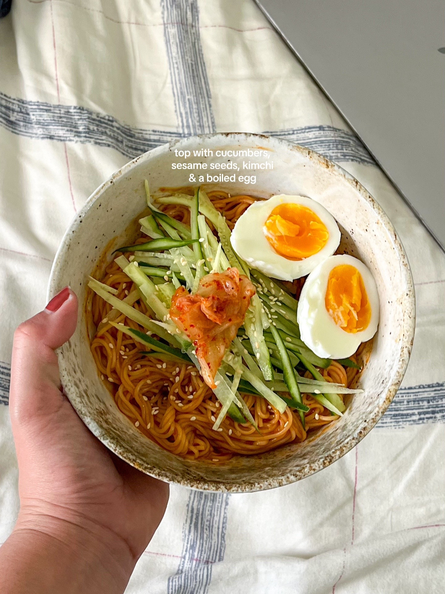 How to make Bibim Guksu: A quick and easy cold noodle dish with sliced cucumbers, soft-boiled eggs, and kimchi