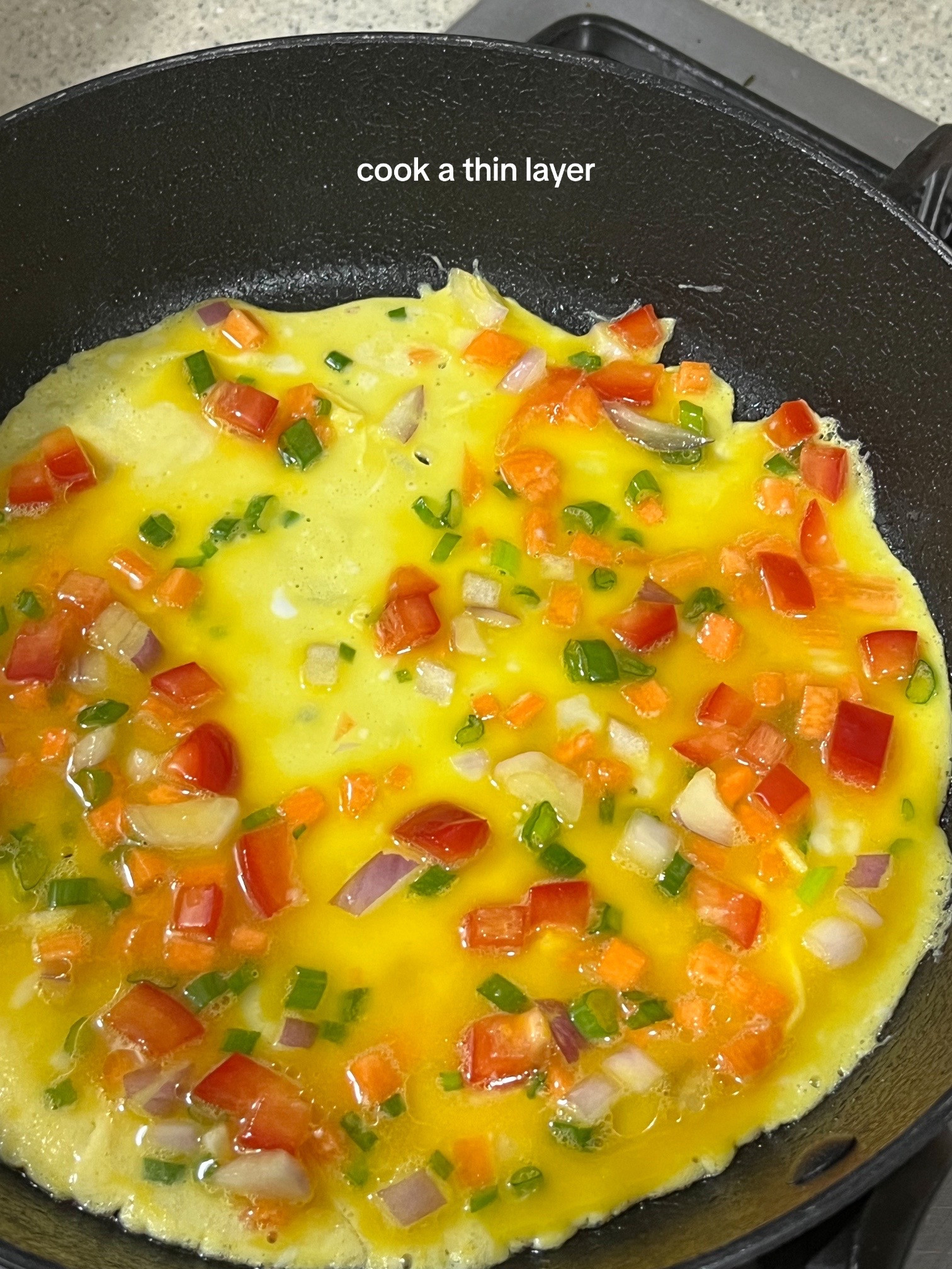 How to make Korean egg rolls with colorful diced vegetables, onions, and spring onions seasoned with sesame oil