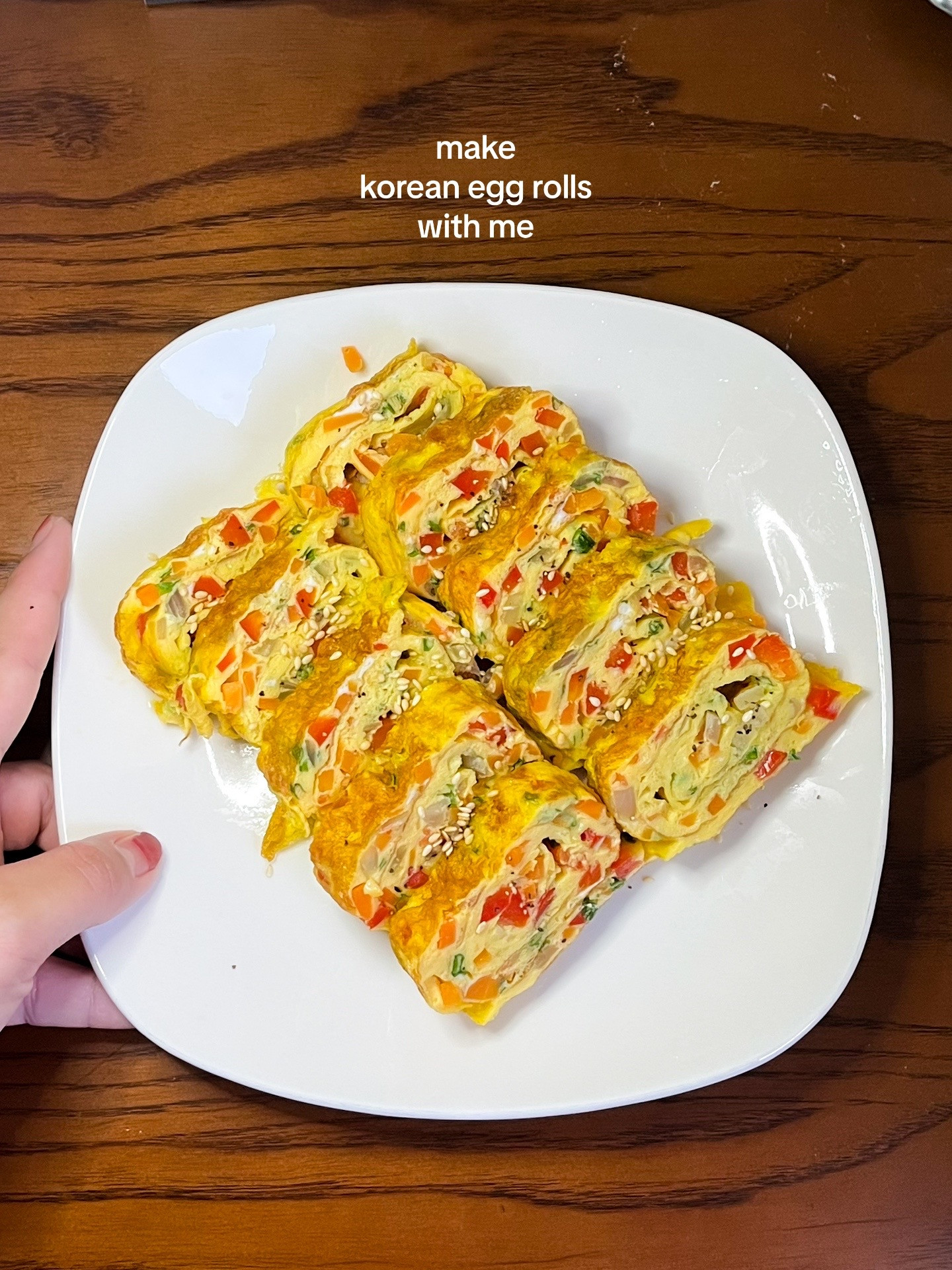 How to make Korean egg rolls with colorful diced vegetables, onions, and spring onions seasoned with sesame oil