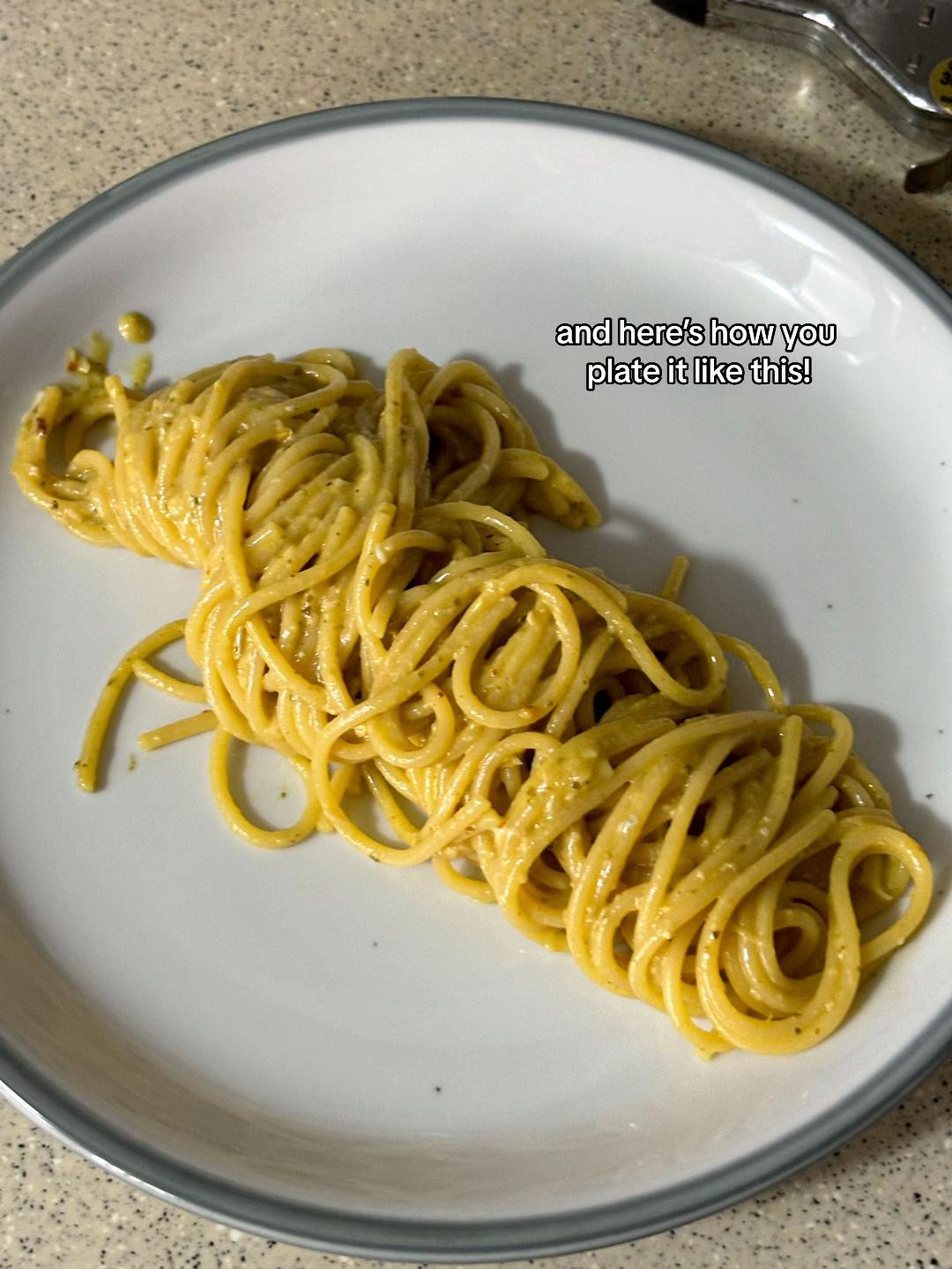 How to plate pesto pasta with minced garlic and Barilla Genovese sauce