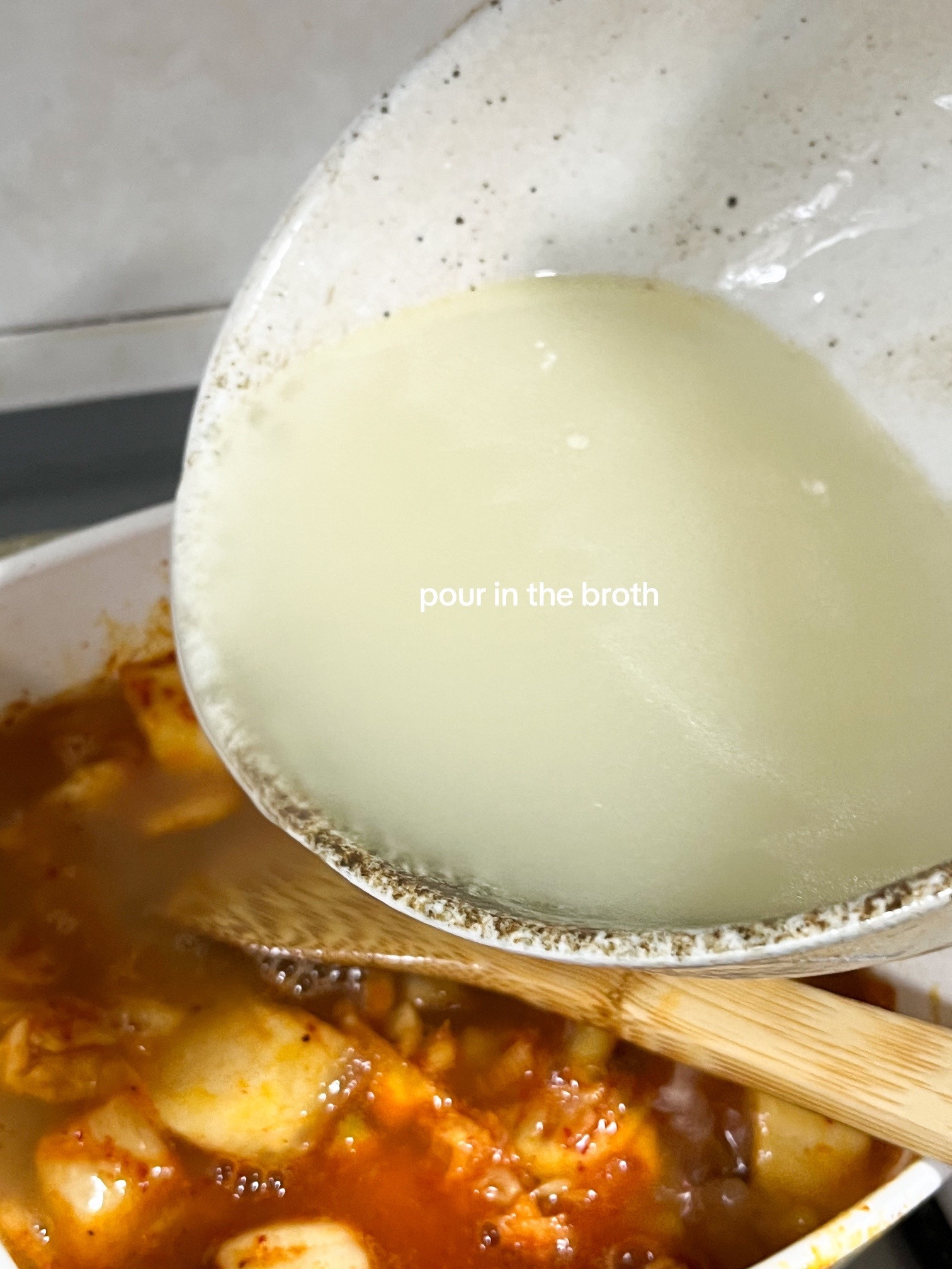 Make kimchi jjigae with me: Korean spicy tofu soup recipe using anchovies, kombu broth, scallions, onions and garlic