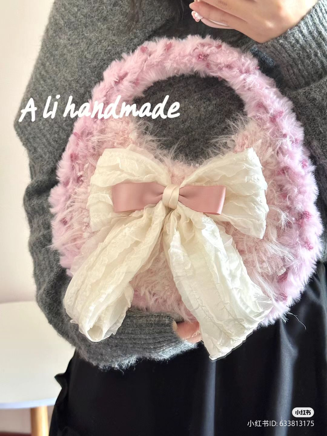 Pink fluffy crocheted handbag with large cream bow pattern