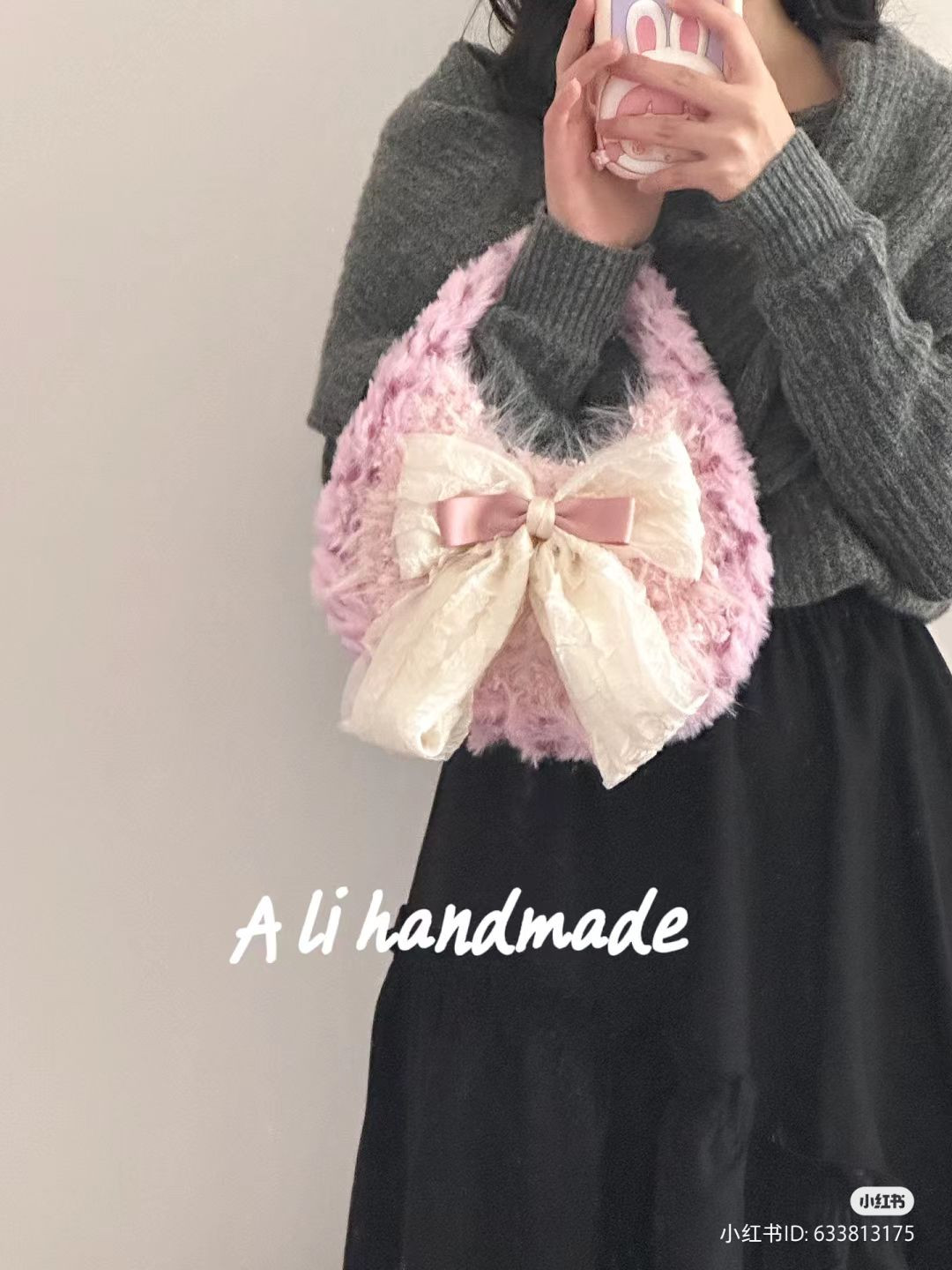 Pink fluffy crocheted handbag with large cream bow pattern
