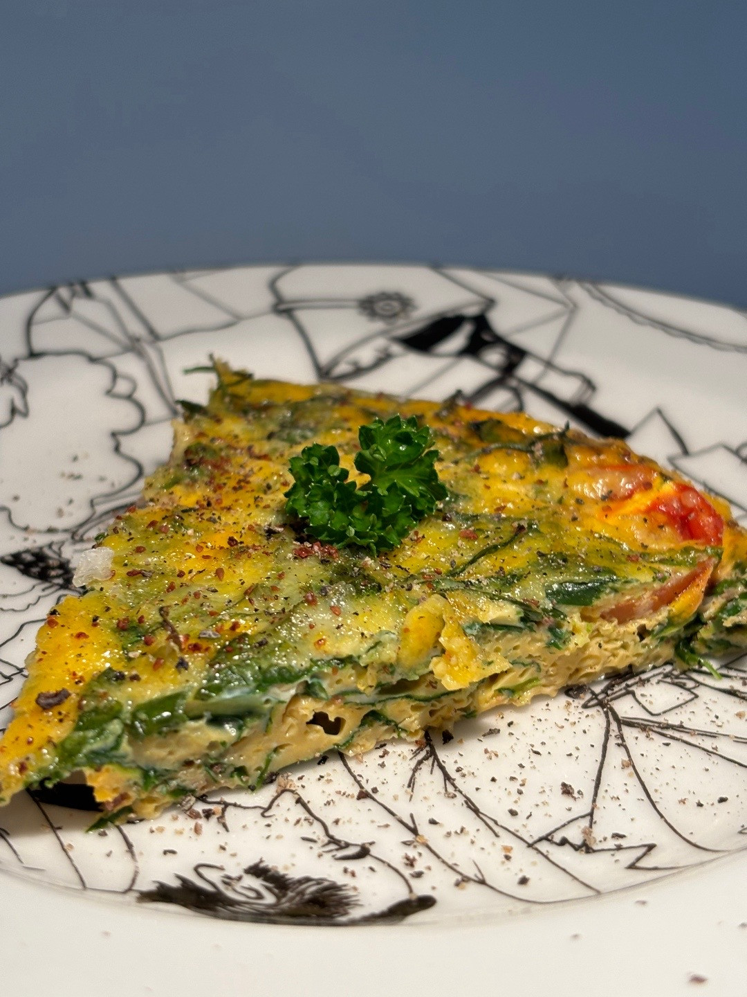 Quick, easy, healthy breakfast frittata with cherry tomatoes and greens cooked in Le Creuset cast iron skillet