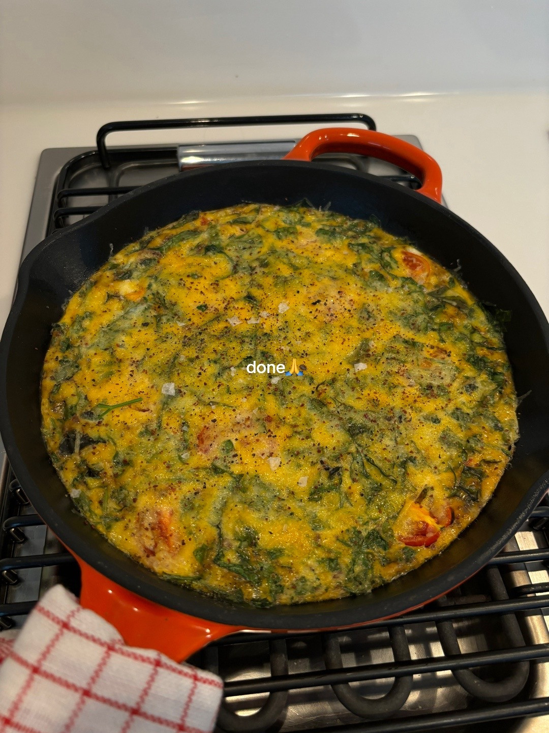Quick, easy, healthy breakfast frittata with cherry tomatoes and greens cooked in Le Creuset cast iron skillet