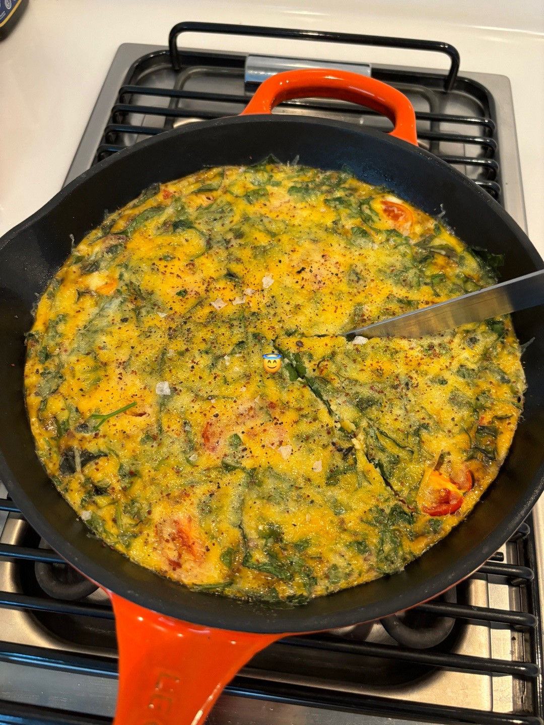 Quick, easy, healthy breakfast frittata with cherry tomatoes and greens cooked in Le Creuset cast iron skillet