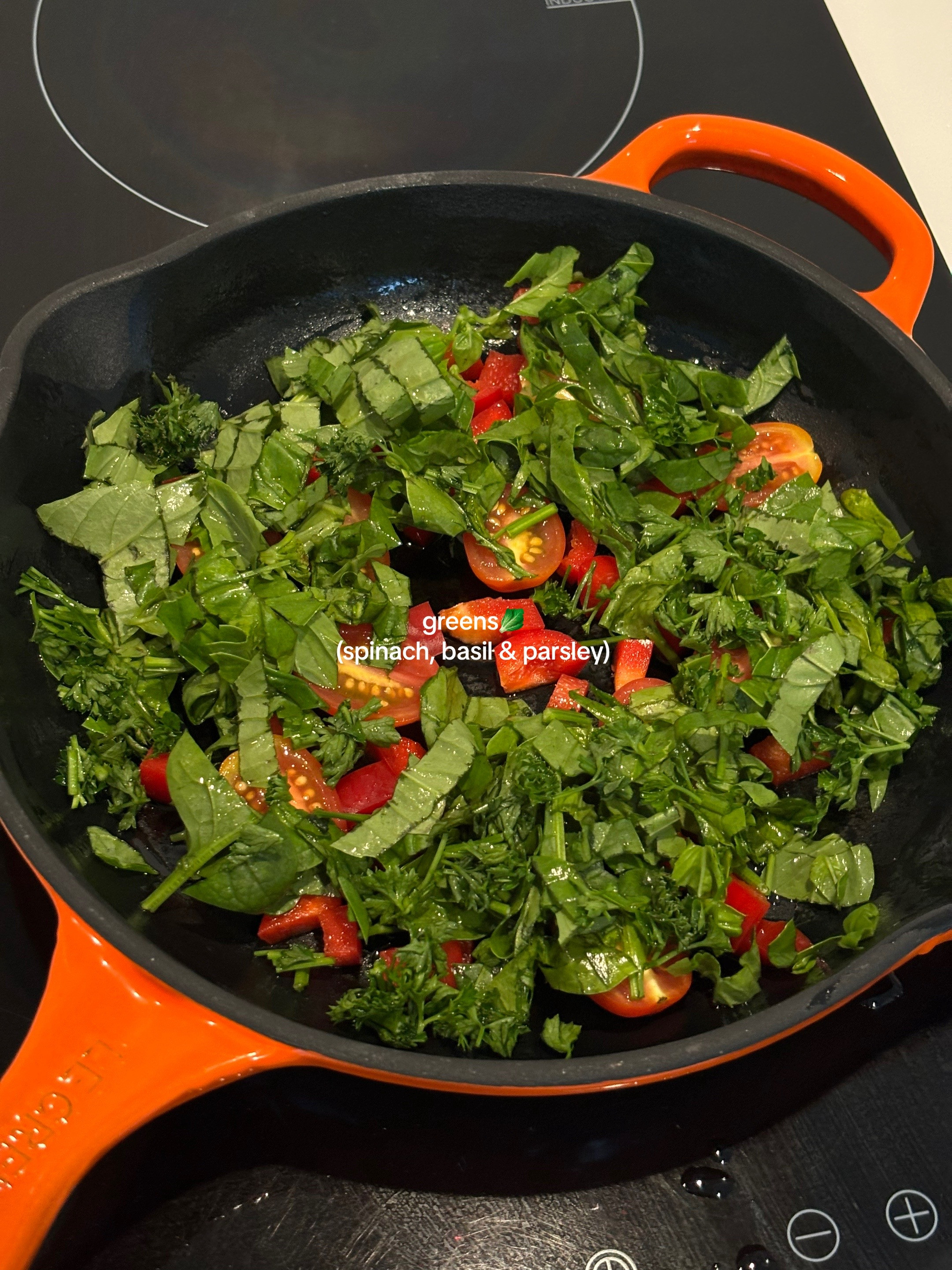 Quick, easy, healthy breakfast frittata with cherry tomatoes and greens cooked in Le Creuset cast iron skillet