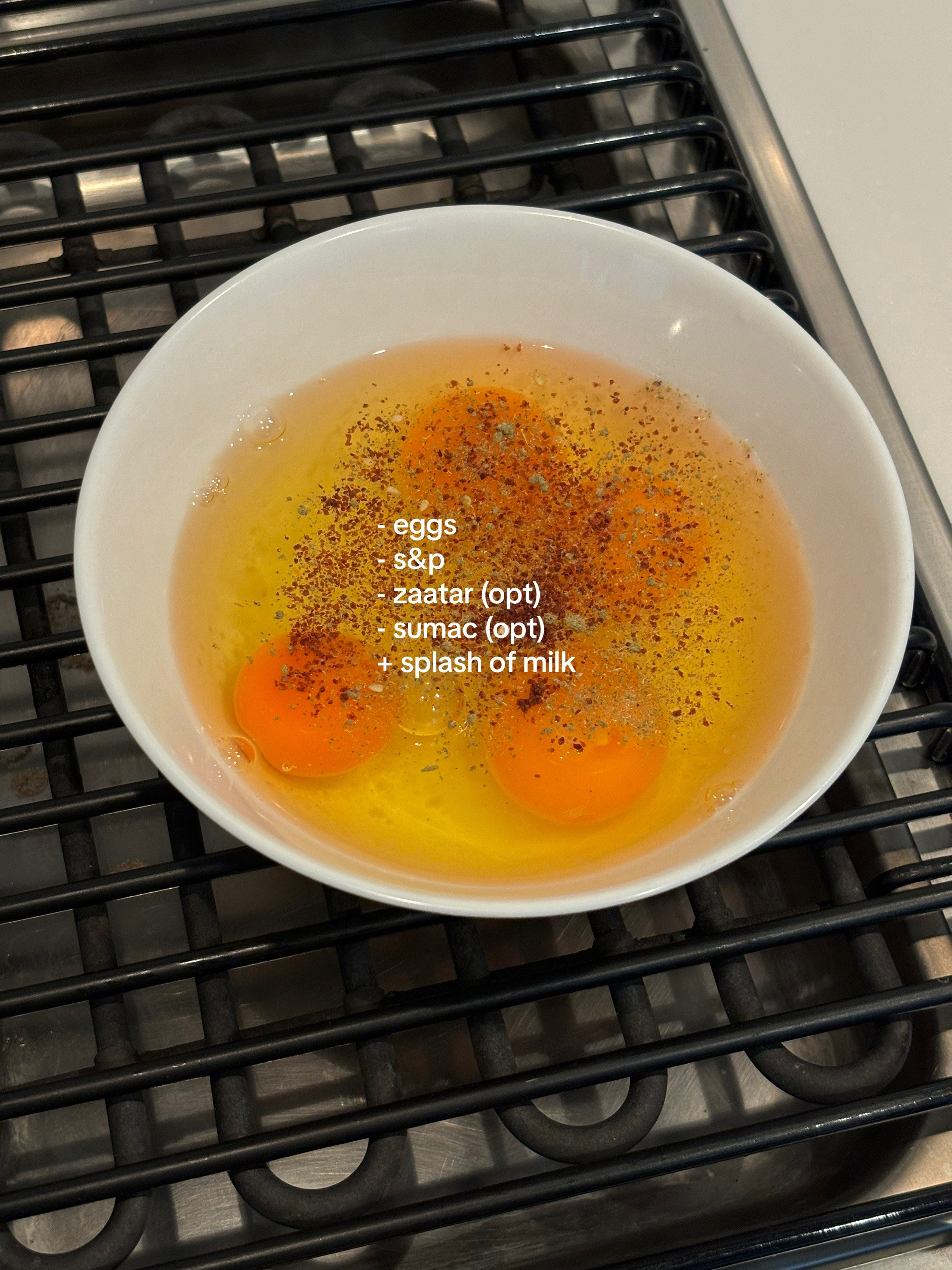 Quick, easy, healthy breakfast frittata with cherry tomatoes and greens cooked in Le Creuset cast iron skillet