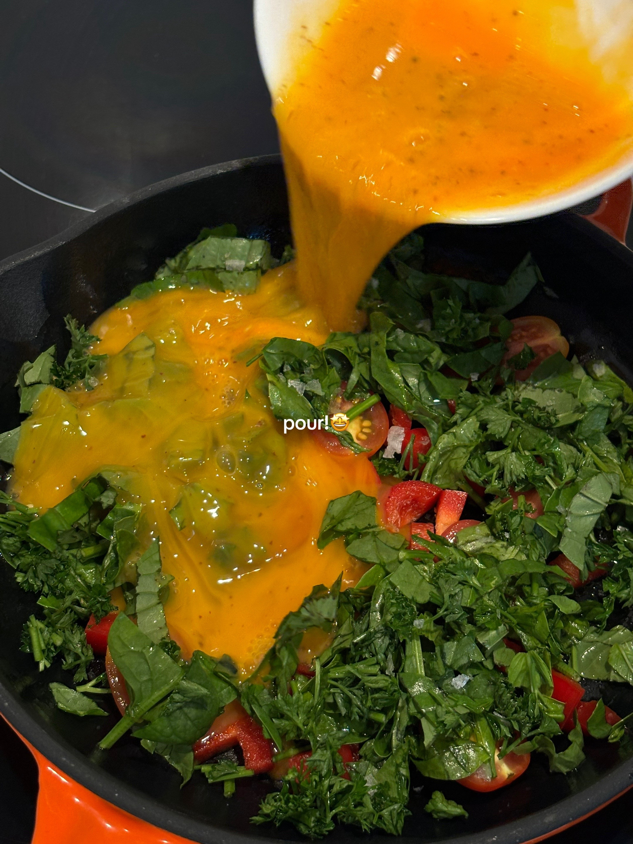 Quick, easy, healthy breakfast frittata with cherry tomatoes and greens cooked in Le Creuset cast iron skillet