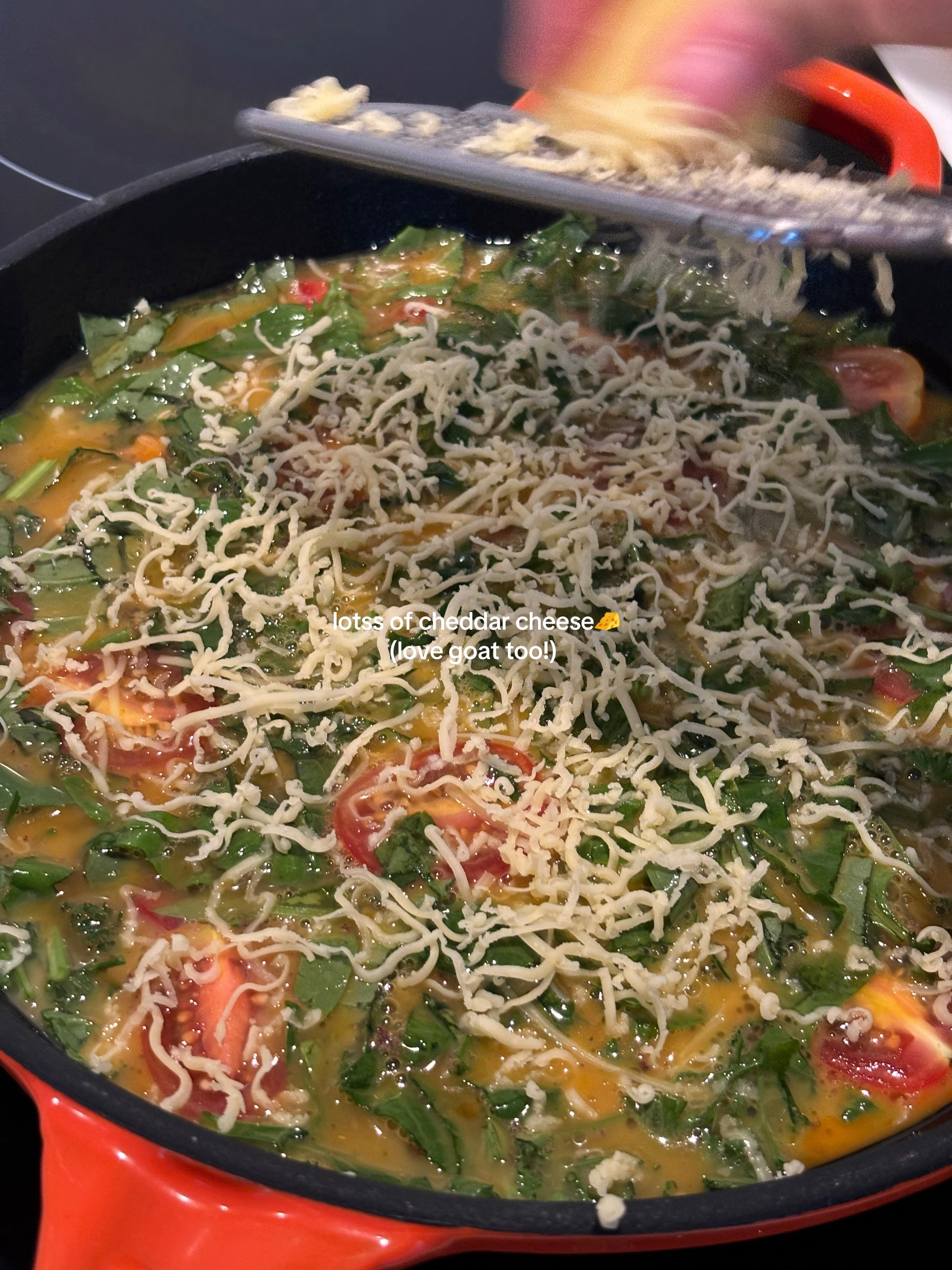 Quick, easy, healthy breakfast frittata with cherry tomatoes and greens cooked in Le Creuset cast iron skillet