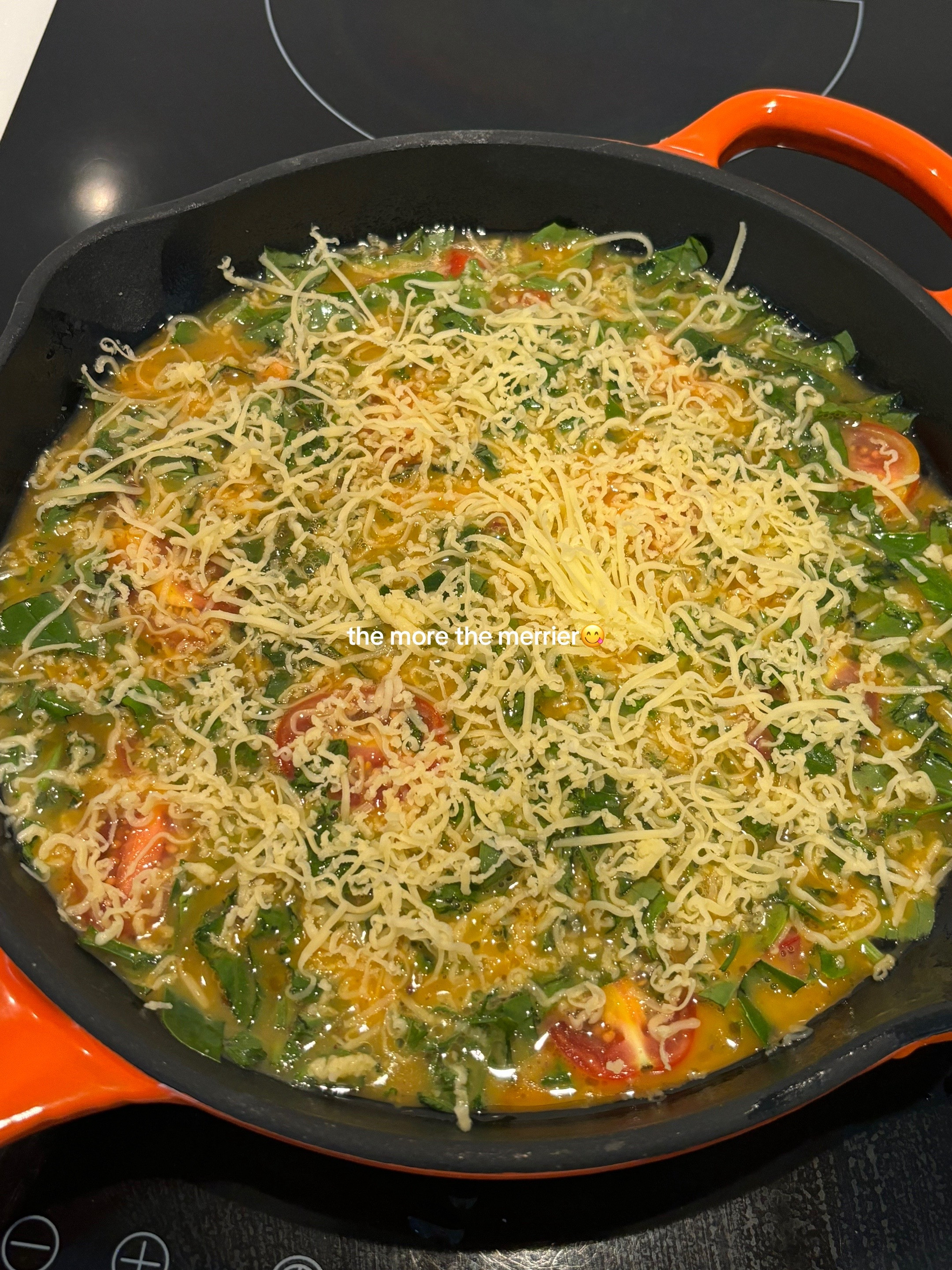Quick, easy, healthy breakfast frittata with cherry tomatoes and greens cooked in Le Creuset cast iron skillet