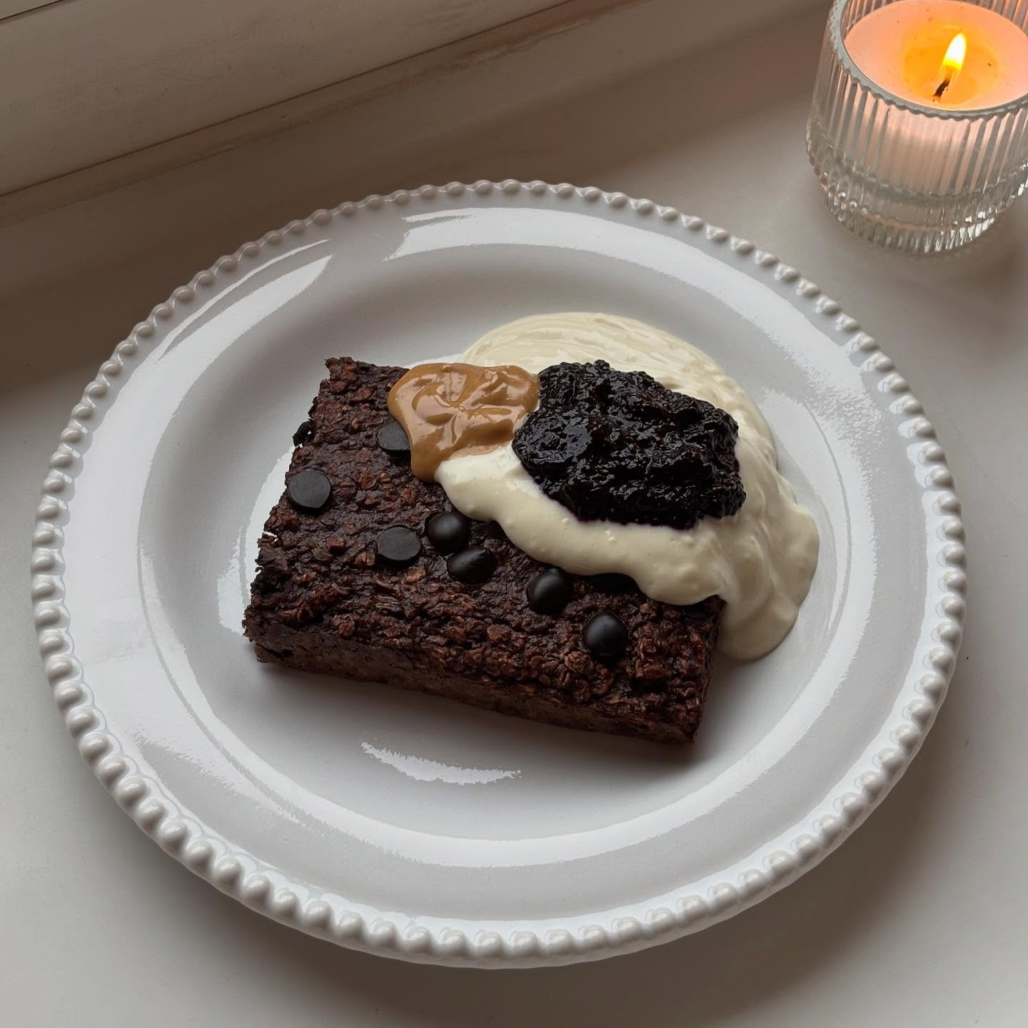 Chocolate Baked Oats with Soy Yogurt, Blueberry Compote and Almond Tonka Butter