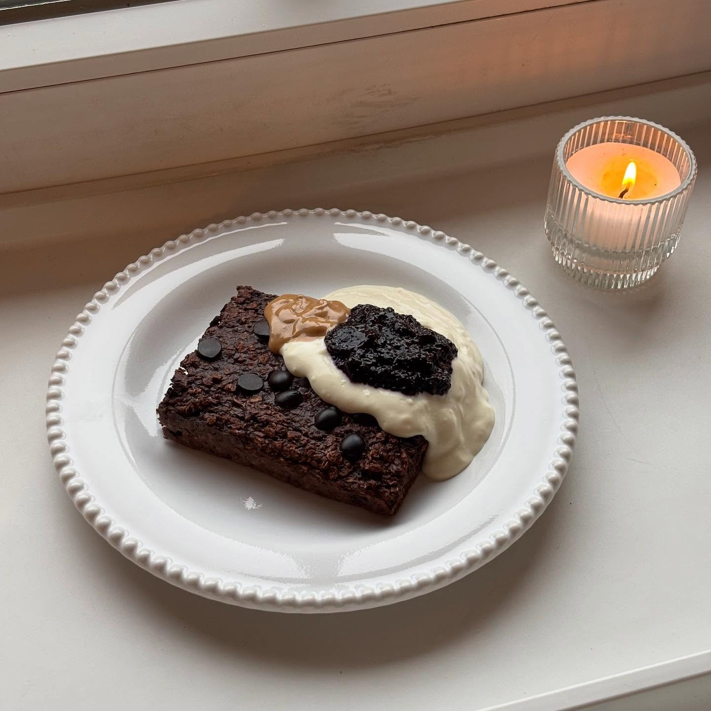 Chocolate Baked Oats with Soy Yogurt, Blueberry Compote and Almond Tonka Butter