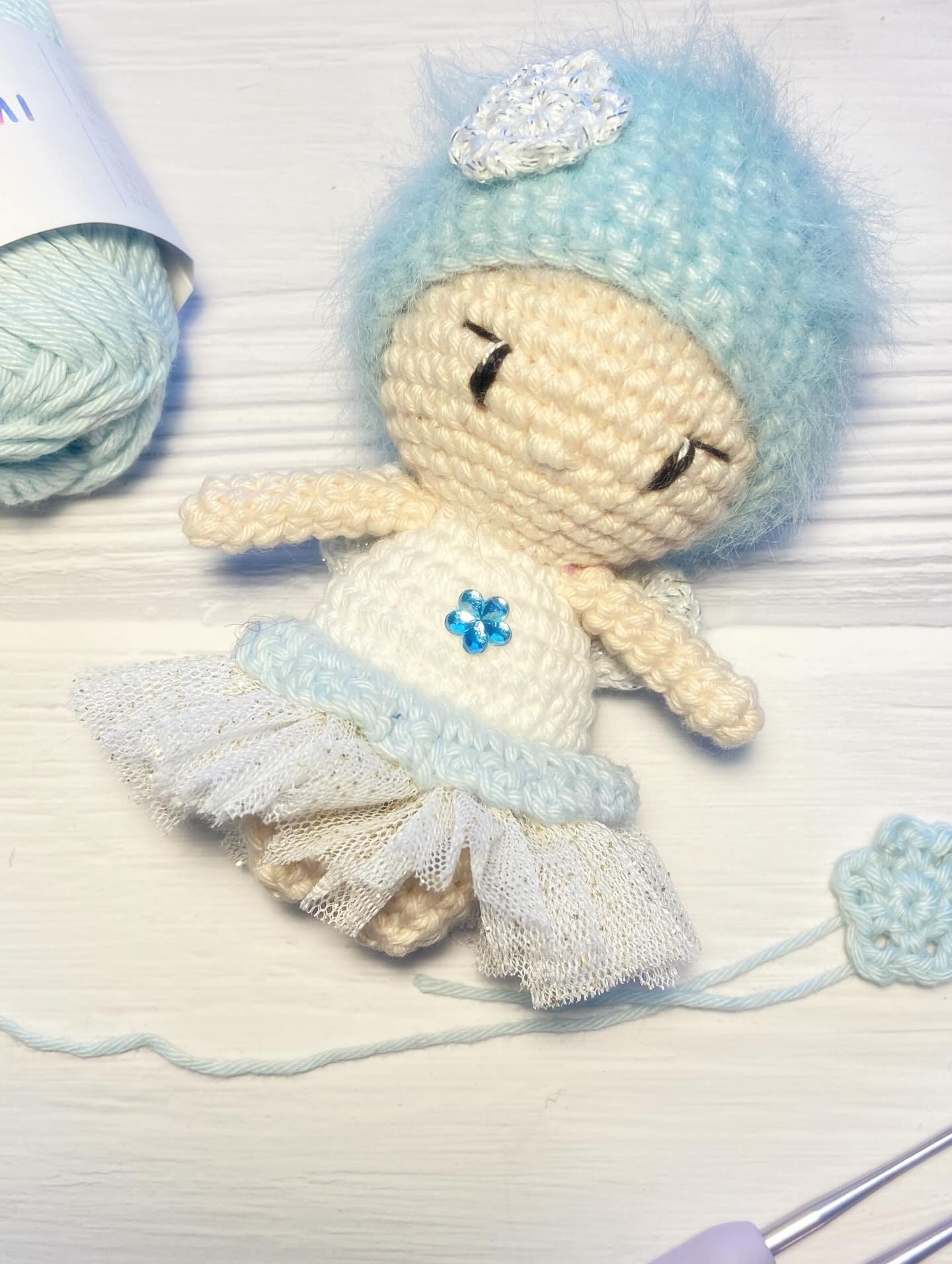 Free Crochet Pattern: Winter Fairy Amigurumi Doll with Blue Hat and Flower Bouquet