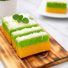 Bol Lapis Singkong: Cake layered cassava steamed yellow and green with buttercream and cheese topping