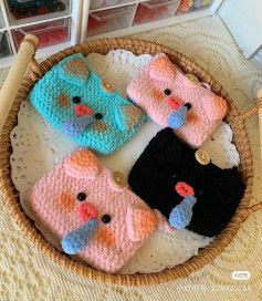 Crochet Pattern Tutorial for Cute Snot Pig Cozies in Pink, Blue, and Black with Button Details