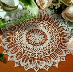 Elegant white floral crochet doily pattern with detailed chart